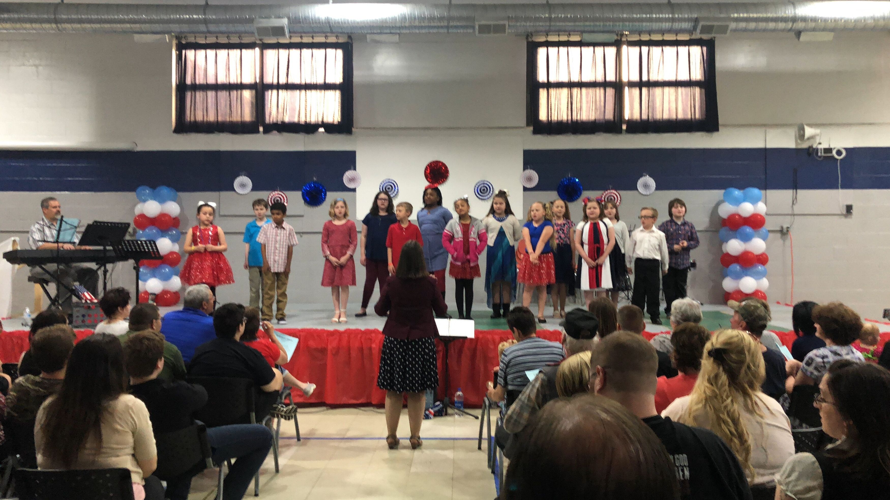 Students singing on stage at concert